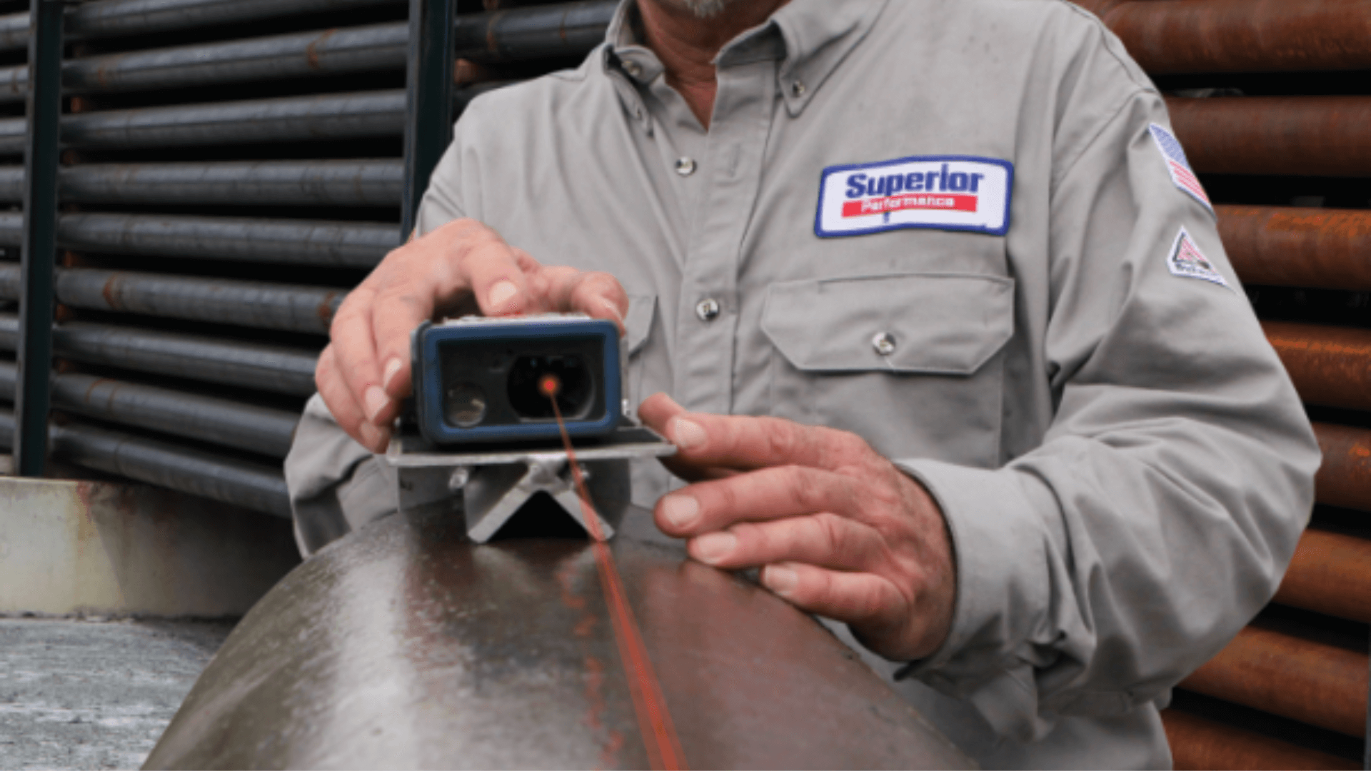 A Superior Performance Field Service Supervisor using a laser tally to measure a pipe. (1)