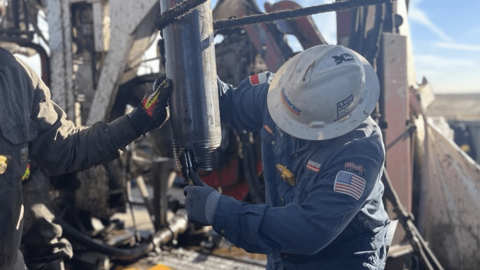 A Superior Performance thread inspector on an oil rig inspecting the threads on a. piece of drilling pipe (2) (1)