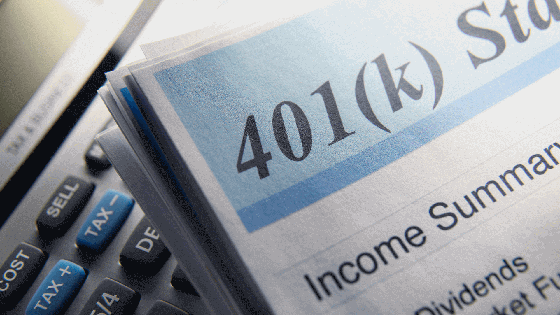 Close-up of a 401(k) retirement account statement showing account balance on top of a calculator, representing retirement savings, financial planning, and long-term investment strategy.